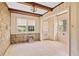 Bright sunroom featuring stone accent wall, windows, and wood trim, perfect for enjoying natural light at 5128 Lavista Rd, Tucker, GA 30084