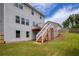 Spacious backyard with a deck and stairs leading down to the grassy area at 6510 Boulder Rdg, Cumming, GA 30028