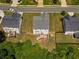Aerial view of a home's backyard with a deck and stairs leading to a grassy fenced yard at 6510 Boulder Rdg, Cumming, GA 30028