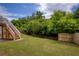 Spacious backyard with wooden fence and a deck, surrounded by lush greenery at 6510 Boulder Rdg, Cumming, GA 30028