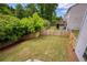 Large fenced backyard with lush grass and mature trees, perfect for outdoor activities and privacy at 6510 Boulder Rdg, Cumming, GA 30028
