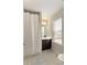 This bathroom features a shower with curtain, modern vanity and tile floors at 6510 Boulder Rdg, Cumming, GA 30028