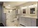 Stylish bathroom with a walk-in shower, double vanity, and modern fixtures at 6510 Boulder Rdg, Cumming, GA 30028