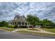 Community clubhouse with a covered porch and landscaped surroundings at 6510 Boulder Rdg, Cumming, GA 30028