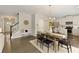 Open dining area with a modern chandelier, table for six, and view of the adjacent kitchen at 6510 Boulder Rdg, Cumming, GA 30028