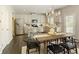Dining area with a view of the modern kitchen with stainless steel appliances and island seating at 6510 Boulder Rdg, Cumming, GA 30028