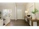 Bright entryway featuring hardwood floors, a console table with decor, and a view of the front door at 6510 Boulder Rdg, Cumming, GA 30028