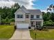 Charming two-story home featuring a well-manicured lawn and a spacious driveway at 6510 Boulder Rdg, Cumming, GA 30028