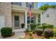 Inviting front porch with gray door, decorative wreath, and landscaped bushes along the walkway at 6510 Boulder Rdg, Cumming, GA 30028