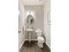 Stylish half bathroom featuring a pedestal sink, toilet, and modern light fixture at 6510 Boulder Rdg, Cumming, GA 30028
