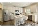 Modern kitchen featuring stainless steel appliances, white cabinets, a kitchen island, and stylish bar stools at 6510 Boulder Rdg, Cumming, GA 30028