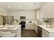 Modern kitchen featuring stainless steel appliances, a kitchen island, and a white subway tile backsplash at 6510 Boulder Rdg, Cumming, GA 30028