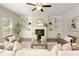 Bright living room featuring a fireplace, built-in cabinets, hardwood floors, and neutral decor at 6510 Boulder Rdg, Cumming, GA 30028