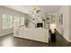 Spacious living room with a fireplace, built-in shelving, hardwood floors, and ample natural light at 6510 Boulder Rdg, Cumming, GA 30028