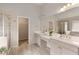 Bright main bathroom with double sink vanity, tiled shower, walk-in closet and large mirror at 6510 Boulder Rdg, Cumming, GA 30028