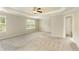 Spacious main bedroom boasts a ceiling fan, tray ceiling and large windows providing plenty of natural light at 6510 Boulder Rdg, Cumming, GA 30028