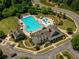 Aerial view of a pool, kiddie pool, clubhouse, lounge chairs, and tables at 6510 Boulder Rdg, Cumming, GA 30028