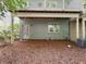 View of backyard with ground level entry and view of upper deck and foliage at 2506 Skyland Ne Dr # 17, Atlanta, GA 30319