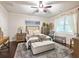 Comfortable bedroom featuring a ceiling fan, neutral decor, hardwood floors, and a large window at 2506 Skyland Ne Dr # 17, Atlanta, GA 30319