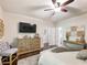 Spacious bedroom with hardwood floors, ceiling fan, large dresser, and cozy chair at 2506 Skyland Ne Dr # 17, Atlanta, GA 30319