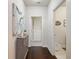 Hallway with dark wood floors leading to the laundry room, featuring elegant artwork and a stylish cabinet at 2506 Skyland Ne Dr # 17, Atlanta, GA 30319
