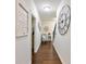 Hallway with wood floors, decorative wall art, blue chair, and access to the staircase at 2506 Skyland Ne Dr # 17, Atlanta, GA 30319
