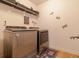 Well-equipped laundry room with modern washer and dryer, plus ample shelving at 3137 Spicy Cedar Ln, Lithonia, GA 30038