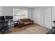 Carpeted bedroom with natural light, closet, desk, and seating area at 3626 Buford Ne Hwy # C1, Brookhaven, GA 30329