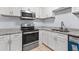 Modern kitchen with white cabinetry, granite counters, and stainless steel appliances at 3626 Buford Ne Hwy # C1, Brookhaven, GA 30329