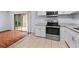Bright kitchen features stainless steel appliances, light countertops, and sliding doors to the outside at 3626 Buford Ne Hwy # C1, Brookhaven, GA 30329