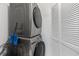 Modern, stacked washer and dryer unit with storage, ideal for convenient laundry access at 3626 Buford Ne Hwy # C1, Brookhaven, GA 30329