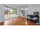 Living room featuring wood floors, access to patio, and view of the kitchen at 3626 Buford Ne Hwy # C1, Brookhaven, GA 30329
