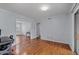 Living room with wood floors, neutral paint, and access to multiple rooms at 3626 Buford Ne Hwy # C1, Brookhaven, GA 30329