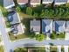 Aerial view of neighborhood with manicured lawns, mature trees, and well-maintained streets at 5909 Rue Chase Way, Tucker, GA 30084