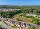 An aerial view of a neighborhood pond surrounded by trees and lush greenery at 5909 Rue Chase Way, Tucker, GA 30084