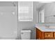 Bathroom with white tiled shower and tub combination, and a cherry vanity at 5909 Rue Chase Way, Tucker, GA 30084