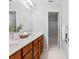 Bright bathroom featuring a double sink vanity with wooden cabinets and a view into the shower at 5909 Rue Chase Way, Tucker, GA 30084