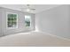 Neutral bedroom featuring carpet and natural light from two windows at 5909 Rue Chase Way, Tucker, GA 30084