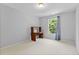 Bright bedroom with neutral walls, carpet, and a wood desk near a window at 5909 Rue Chase Way, Tucker, GA 30084