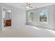 Neutral bedroom with an ensuite bathroom, lots of natural light, and carpet at 5909 Rue Chase Way, Tucker, GA 30084