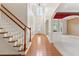 Bright foyer with hardwood floors, high ceilings, staircase, and natural light streaming through a large window at 5909 Rue Chase Way, Tucker, GA 30084
