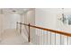 Hallway with carpet and decorative railing leading to a bedroom at 5909 Rue Chase Way, Tucker, GA 30084