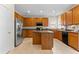 Spacious kitchen featuring wood cabinets, stainless steel refrigerator, and a functional center island at 5909 Rue Chase Way, Tucker, GA 30084