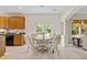 Bright eat-in kitchen with wood cabinets, stainless steel appliances, and access to the outdoors at 5909 Rue Chase Way, Tucker, GA 30084