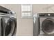 Bright laundry room featuring a side-by-side washer and dryer set and a window for natural light at 5909 Rue Chase Way, Tucker, GA 30084