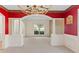 Bright living room with wainscotting, chandelier, a view to the yard from a large window at 5909 Rue Chase Way, Tucker, GA 30084