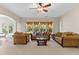 Bright living room with large windows, comfortable seating, and seamless flow into the kitchen at 5909 Rue Chase Way, Tucker, GA 30084