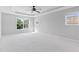 Bright main bedroom with trey ceiling, ceiling fan and large windows at 5909 Rue Chase Way, Tucker, GA 30084