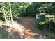 Aerial view of the property showing a shed and wooded area at 6675 Millwood Rd, Cumming, GA 30041