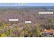 Scenic aerial view of property, Fourmile Creek, and Lake Lanier with nearby points of interest at 6675 Millwood Rd, Cumming, GA 30041
